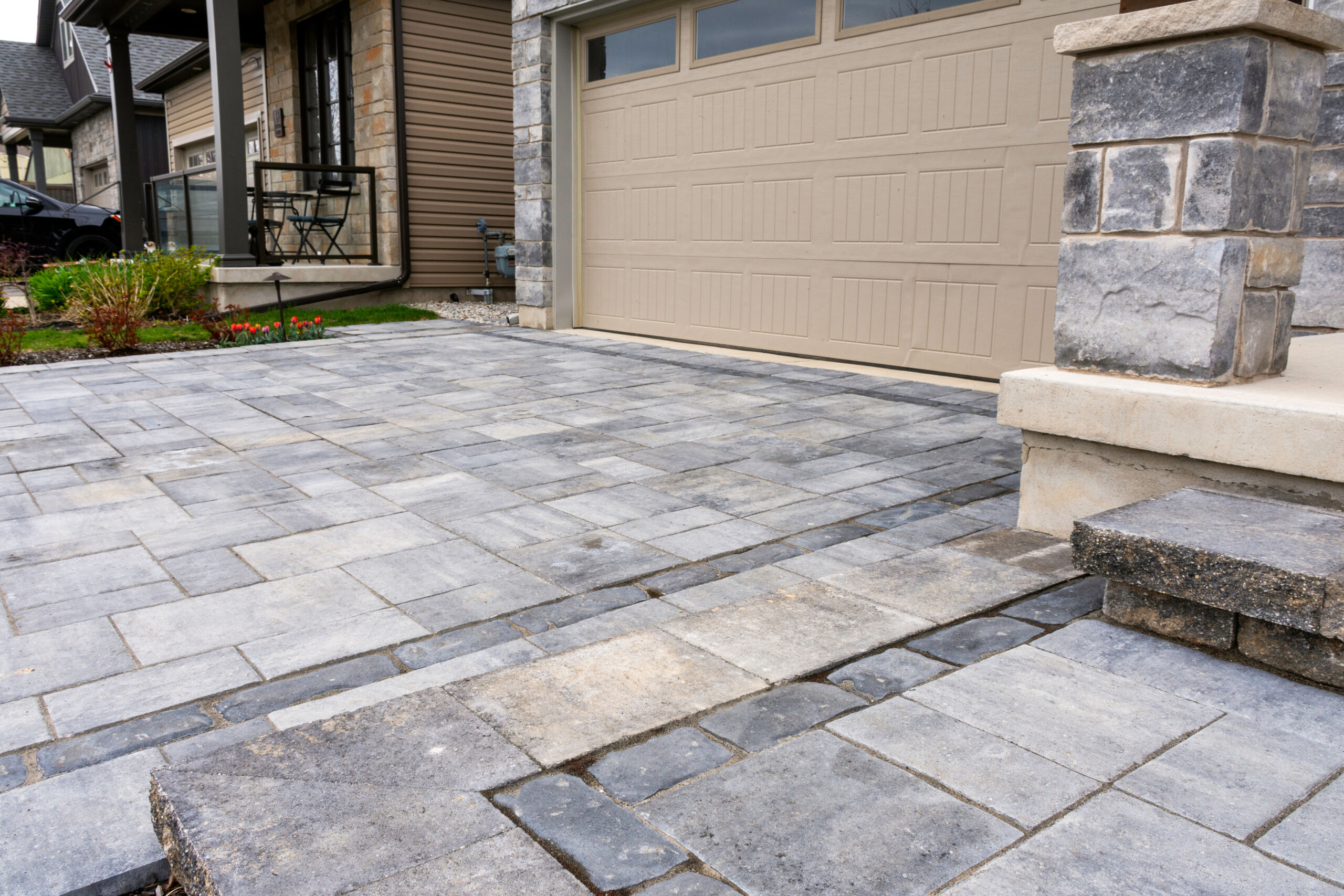 Luxury hardscape driveway shows pavers with pattern and and mat