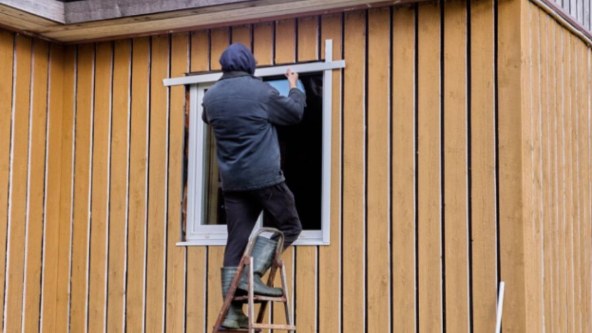 Man fixing exterior of a home