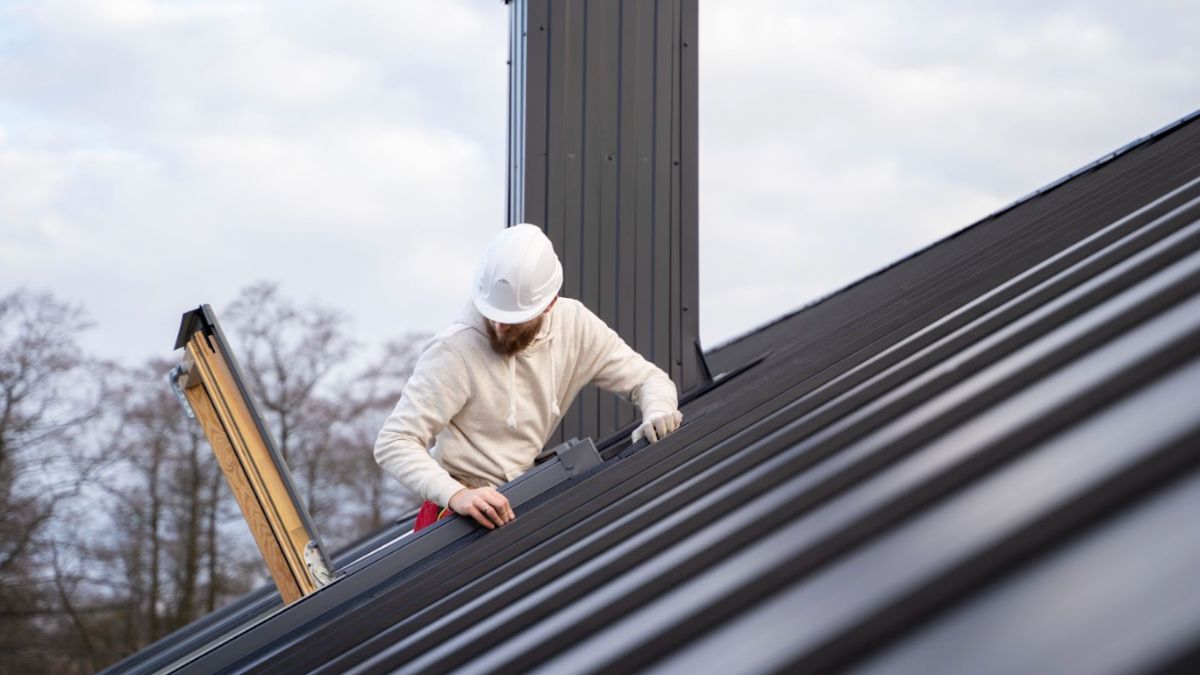 Man Doing Roofing Repairs on Roof