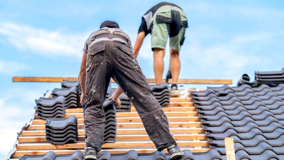 Two Men Finishing Up Roof